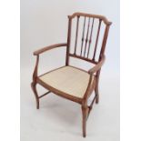 An Edwardian lightwood chair with spindle back