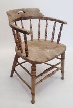 An early 20th century spindle back Captains chair