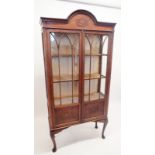 A 1930's oak two door arch top display cabinet, 183cm high x 88cm wide x 33cm deep