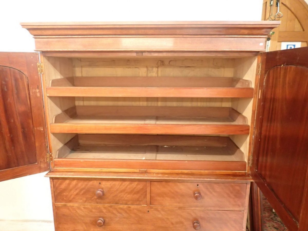 A 19th century mahogany small linen press with two arch panelled doors enclosing trays all over - Image 2 of 3
