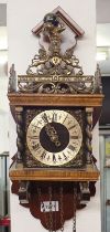 A Dutch style wall clock with figure of Atlas, 48cm