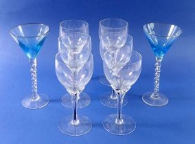 A set of six vintage wine glasses with black stems and a pair of turquoise bowl cocktail glasses