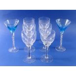 A set of six vintage wine glasses with black stems and a pair of turquoise bowl cocktail glasses