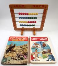 A vintage childs abacus and two 1960's annuals
