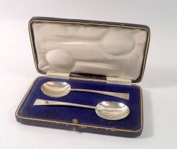 A pair of silver Arts & Crafts style christening spoons, cased, Sheffield 1916, 43g by Thomas