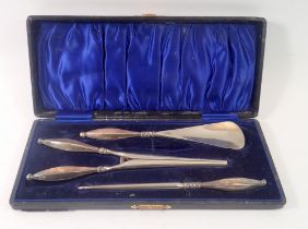 A silver dressing table set including glove stretchers, shoe horn and button hook, 1913, by Adie &