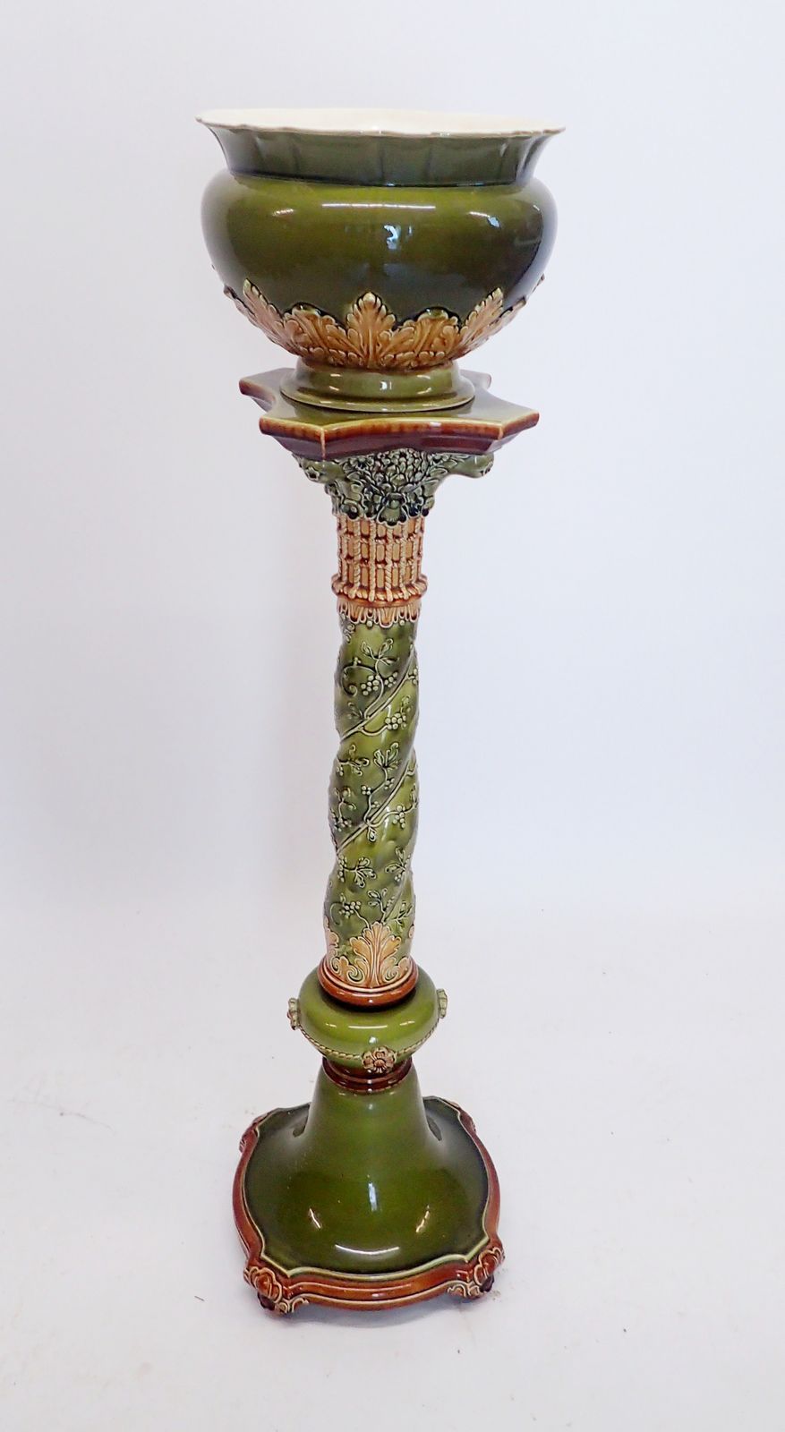 A green Villeroy & Boch Majolica jardiniere and stand decorated mistletoe and leaf decoration,