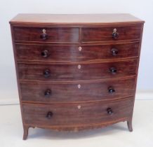 An early 19th century bow fronted mahogany chest of two short and four long drawers with bone