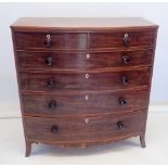 An early 19th century bow fronted mahogany chest of two short and four long drawers with bone