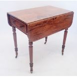 An early 19th century mahogany Pembroke table in the manner of Gillows with reeded legs and castors,