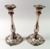 A pair of 19th century silver plated candlesticks with scrollwork decoration, 25cm