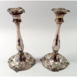 A pair of 19th century silver plated candlesticks with scrollwork decoration, 25cm