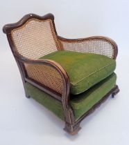 A Victorian bergere armchair with singe cane back and sides