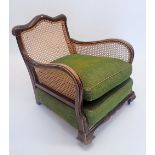 A Victorian bergere armchair with singe cane back and sides