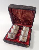 A Victorian set of six silver plated napkin rings decorated leaves, cased