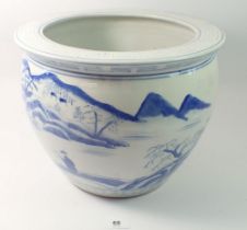 A Chinese blue and white jardiniere painted landscapes 24cm tall