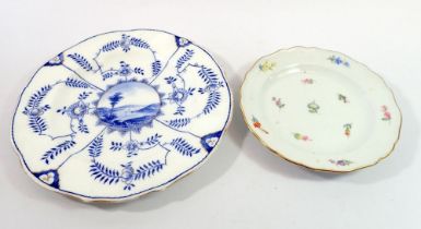 A Meissen plate painted sprigs of flowers, 18cm diameter and a Meissen style blue and white plate