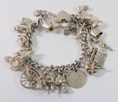 A silver charm bracelet and quantity of silver and white metal charms