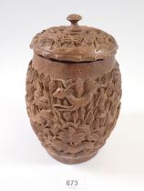 A 1960's Indian carved wooden pot and lid decorated jungle and animal scenes, 19cm tall