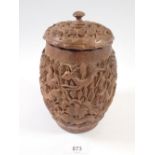 A 1960's Indian carved wooden pot and lid decorated jungle and animal scenes, 19cm tall