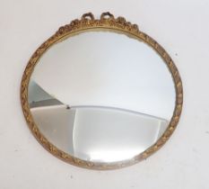 A circular gilt framed convex mirror with ribbon surmount, 48cm