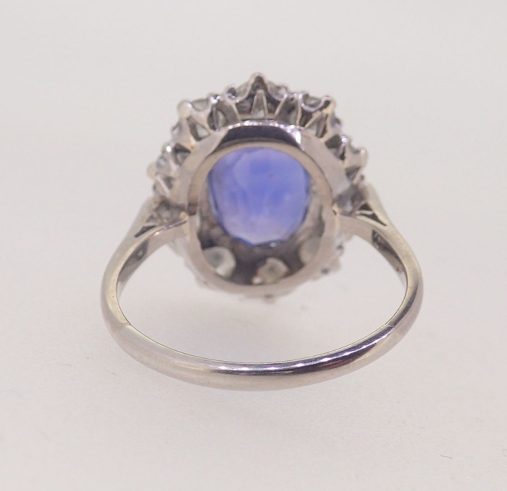 A fine Ceylon sapphire and diamond cluster ring, the sapphire 11mm x 8mm, ring size O, 4.8g - Image 6 of 7