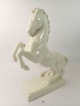 A large white pottery model of a horse, 36cm tall