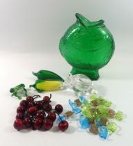 A collection of coloured glass items including Murano sweets, glass cherries, fish jug etc.