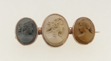 A 19th century gold brooch set three lava carved cameos in three colours, boxed, 3.3cm wide