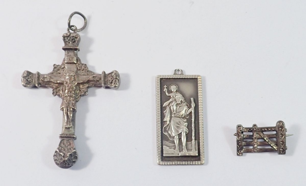 A silver St Christopher pendant 14g, a white metal large crucifix and a silver gate brooch