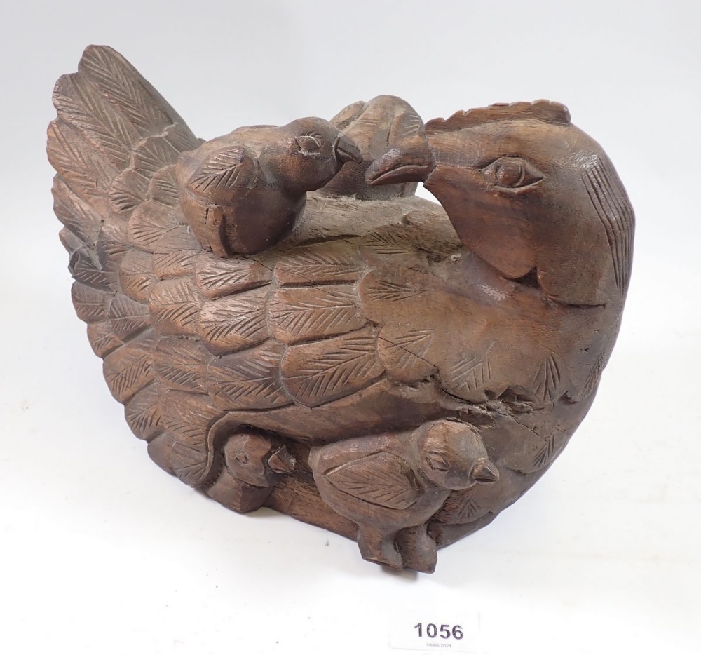 A large carved wood chicken and chicks, 32cm long