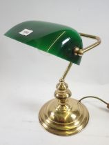 A brass desk lamp with green glass shade, 37cm tall