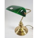 A brass desk lamp with green glass shade, 37cm tall