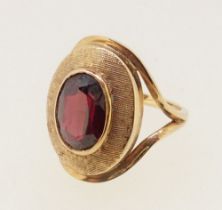 A 9 carat gold oval ring set garnet, 4.5g, size N to O