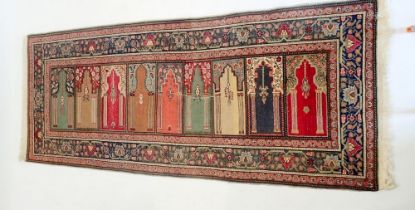 A Persian family prayer rug with five arched panels, 217 x 92cm