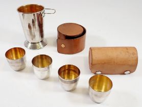 A set of four stirrup cups with gilt interiors in leather case plus a collapsible stirrup cup with