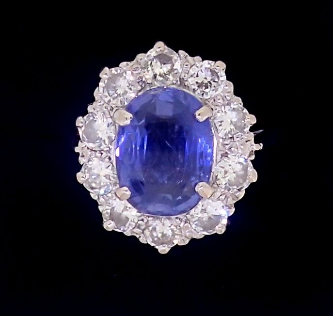 A fine Ceylon sapphire and diamond cluster ring, the sapphire 11mm x 8mm, ring size O, 4.8g