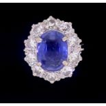 A fine Ceylon sapphire and diamond cluster ring, the sapphire 11mm x 8mm, ring size O, 4.8g