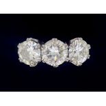 A fine platinum set three stone diamond ring - approximately three carats in total, 7.8g