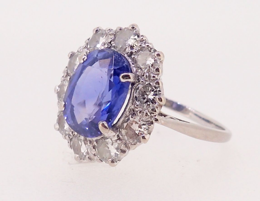 A fine Ceylon sapphire and diamond cluster ring, the sapphire 11mm x 8mm, ring size O, 4.8g - Image 3 of 7