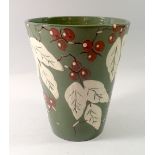 An Art Pottery flared vase painted leaves and berries, 20cm