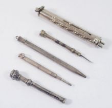 Four various white metal pencils and a toothpick