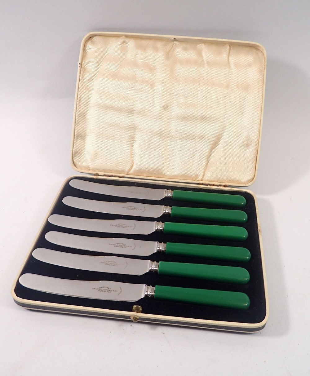 A vintage set of six green handled tea knives, cased