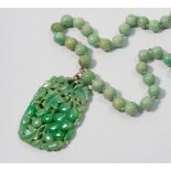 A fine Chinese jade bead necklace with vine carved decorative panel, panel 5 x 3.8cm - bead necklace