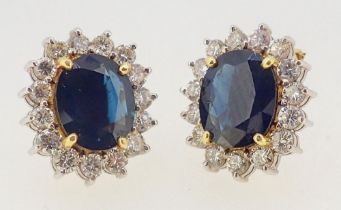A pair of 18 carat gold sapphire and diamond cluster earrings with chips and pierced fittings