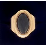 An early 19th century gold ring set cabochon oval cut stone, inscribed within 'Edw Hippsley Esq 06