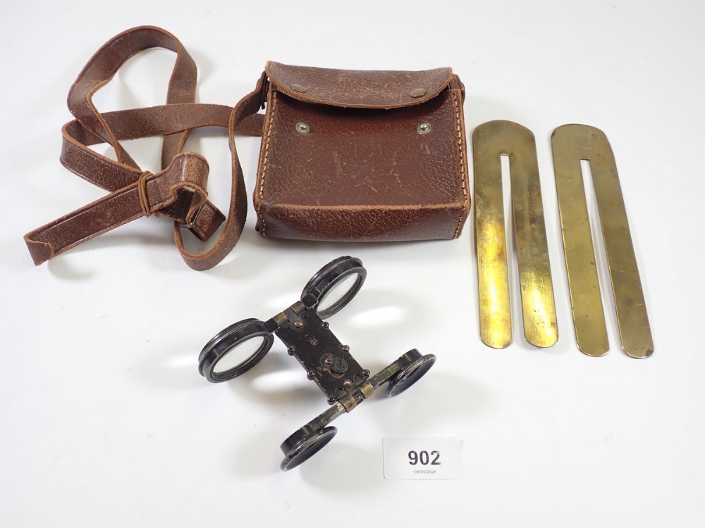 Two military button polishing bars and a pair of folding opera glasses