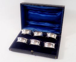 A set of six silver napkin rings, hallmarked Chester 1911 in original fitted case by Barker Brothers