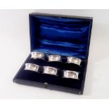 A set of six silver napkin rings, hallmarked Chester 1911 in original fitted case by Barker Brothers