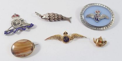 A silver sweetheart brooch, two other sweetheart brooches and a 9 carat gold teapot charm